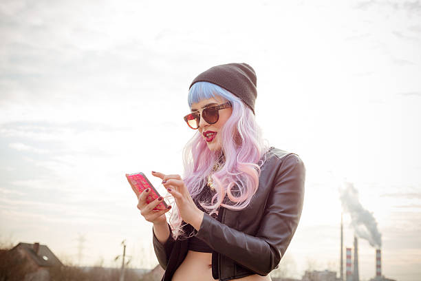 A young woman with trendy pastel hair checks her phone, illustrating the fusion of social media and fashion.