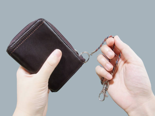 Person demonstrating how to wear a wallet chain as a fashion accessory